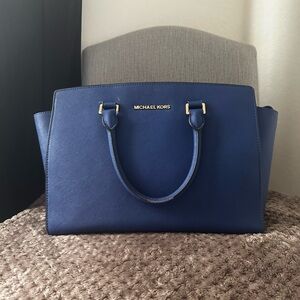 Blue Michael Kors bag with dust bag.